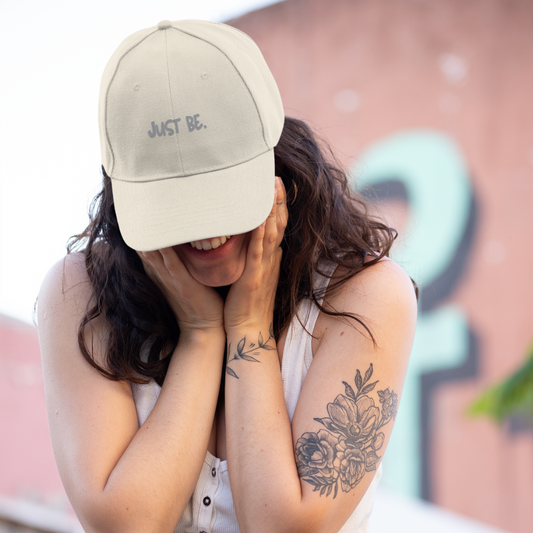 girl with tattoos wearing cream mindful living embroidered organic cotton cap