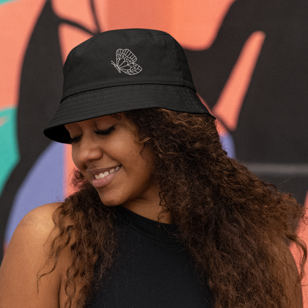 woman wearing black butterfly embroidery organic cotton bucket hat