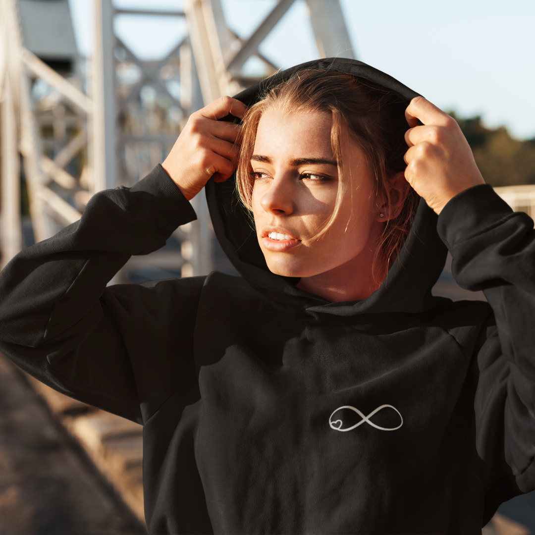 woman wearing black infinity embroidered hoodie