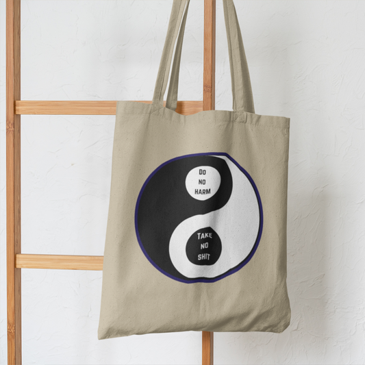 funny ying and yang natural tote bag hanging on ladder