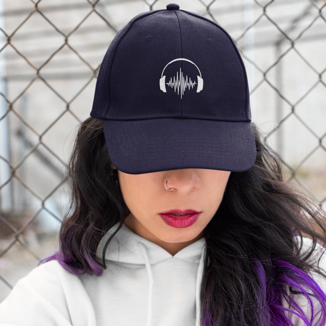 Girl with purple hair wearing embroidery headphones navy organic cotton cap